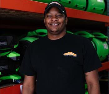 Male in front of servpro equipment with hat on